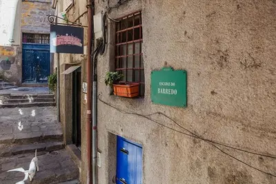a building with a blue door and a sign on it at Stay In Apartments in Porto