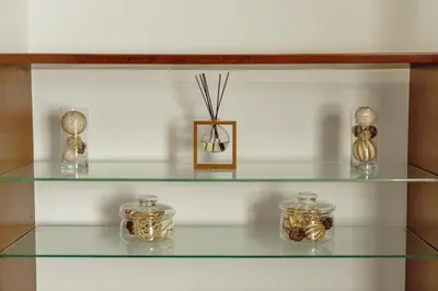 a glass shelf with several glass jars on it at OPORTO GUEST Oliveira House in Porto