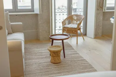 a living room with a table and a chair at OPORTO GUEST Bonfim Apartment in Porto