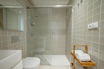 a bathroom with a shower and a toilet and a sink at OPORTO GUEST Bonfim Apartment in Porto