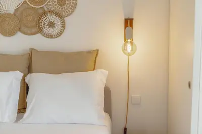 a bedroom with a bed with a white pillow and a lamp at OPORTO GUEST Bonfim Apartment in Porto