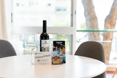 a bottle of wine sitting on a table with a glass at GuestReady - Shades of Blue with Balcony in Porto
