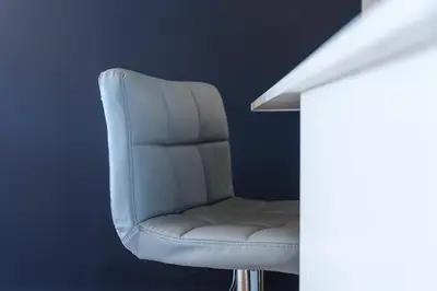 a white chair sitting next to a wall at GuestReady - Shades of Blue with Balcony in Porto