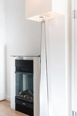 a fireplace in a living room with a stove at GuestReady - Shades of Blue with Balcony in Porto