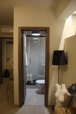 a bathroom with a toilet and a glass door at Apartment Art Jazz Music in Porto