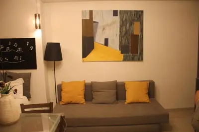 a living room with a couch and a painting at Apartment Art Jazz Music in Porto