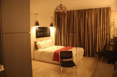 a bedroom with a bed and a chair in a room at Apartment Art Jazz Music in Porto