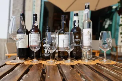 a group of wine bottles and glasses on a wooden table at FLH Porto Clérigos Luxury Apartments in Porto