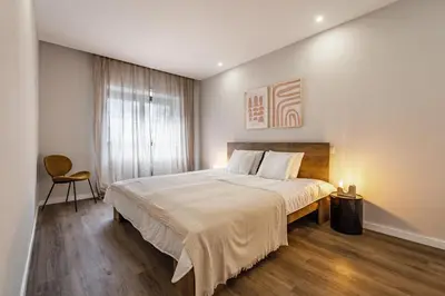 a bedroom with a large bed and a window at Nomad's Family - 2BED Casa da Música in Porto