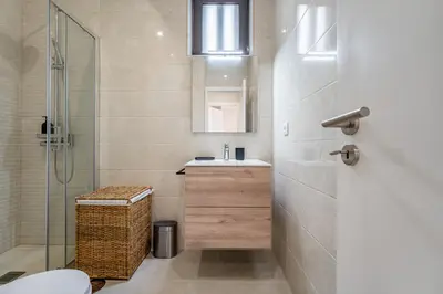 a bathroom with a sink and a shower at Nomad's Family - 2BED Casa da Música in Porto