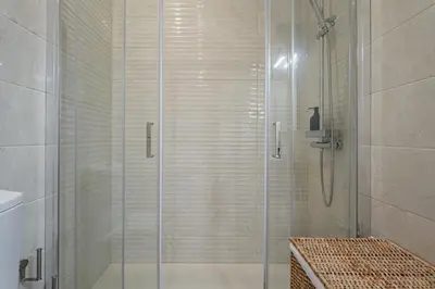 a shower with a glass door in a bathroom at Nomad's Family - 2BED Casa da Música in Porto