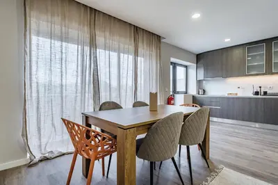 a dining room with a wooden table and chairs at Nomad's Family - 2BED Casa da Música in Porto