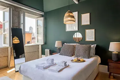 a bedroom with a bed with a tray of fruit on it at Lóios 66 by LovelyStay in Porto