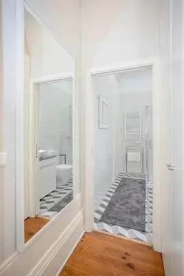 a bathroom with a mirror and a sink and a toilet at Liiiving in Porto - Chic & Sweet Home in Porto