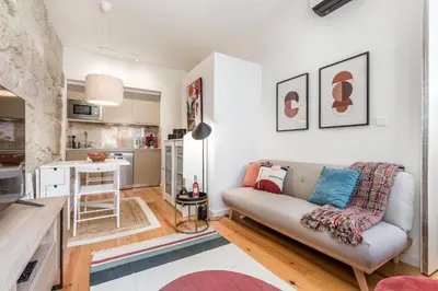 a living room with a couch and a kitchen at OPO Bonjardim 902 II in Porto