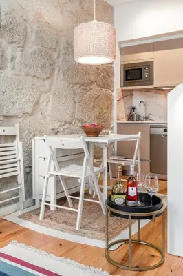 a kitchen with a table with wine glasses on it at OPO Bonjardim 902 II in Porto