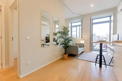a living room with a table and a plant in it at 31 Janeiro 157 - Delightful 1BR Flat w/ AC & Balcony by LovelyStay in Porto