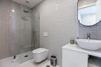 a bathroom with a toilet and a sink and a shower at 31 Janeiro 157 - Charming 1BR Flat w/ AC & Balcony by LovelyStay in Porto