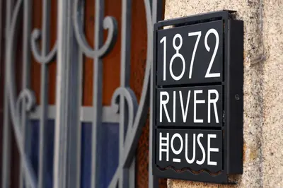 a sign that reads river house attached to a building at 1872 River House by Olivia in Porto