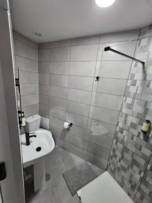 a white bathroom with a sink and a shower at Bonsai Apartment IIII in Porto