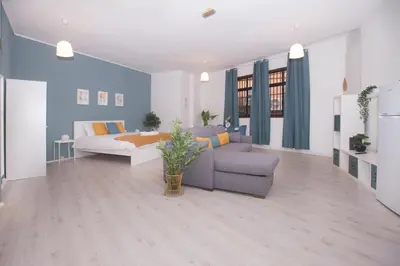 a living room with a couch and a bed at Bonsai Apartment IIII in Porto