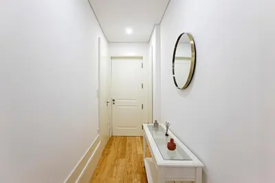 a white bathroom with a mirror and a sink at Casinha da Formosa by Oporto Soul in Porto