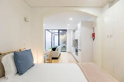 a bedroom with a bed and a living room at Casinha da Formosa by Oporto Soul in Porto