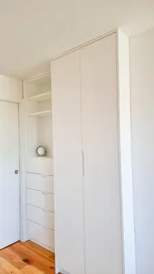 a closet with white cabinets in a room at Jardim do Morro Haus in Vila Nova de Gaia