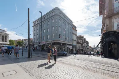 a group of people walking down a city street at Oporto Golden Flat in Porto