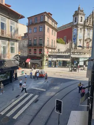 a group of people crossing a street in a city at Oporto Golden Flat in Porto