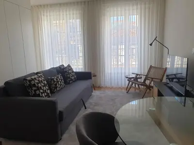 a living room with a couch and a glass table at Oporto Golden Flat in Porto