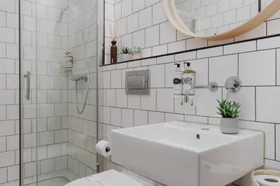 a white bathroom with a sink and a shower at Skyline Cosy House, Downtown Porto near metro in Porto
