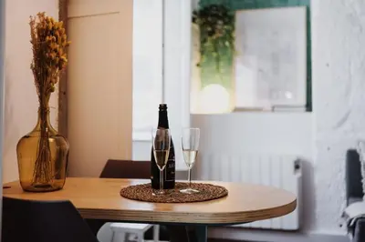 a bottle of wine and a glass on a table at Skyline Cosy House, Downtown Porto near metro in Porto