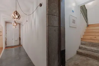 a hallway with stairs and a chandelier at Skyline Cosy House, Downtown Porto near metro in Porto