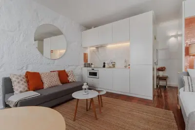 a living room with a couch and a table at Skyline Cosy House, Downtown Porto near metro in Porto