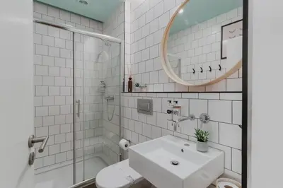 a bathroom with a toilet and a sink and a mirror at Skyline Cosy House, Downtown Porto near metro in Porto