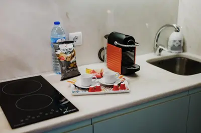 a kitchen counter with two coffee cups and a toaster at Bicycle Luxury House, parking, downtown near metro in Porto