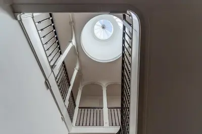 a spiral staircase with a round window in a building at Bicycle Luxury House, parking, downtown near metro in Porto