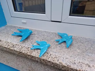 three blue starfish sitting on a counter in front of a door at Casa do Barqueiro - Porto in Porto