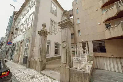 an old building with a gate on a street at Downtown Trindade Apartment With Terrace by Vacationy in Porto