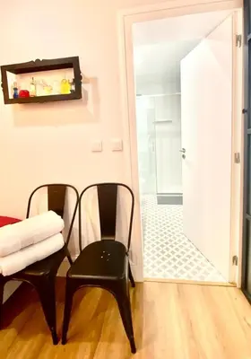 two black chairs and a mirror in a room at Cristelo 0 - near the river Porto in Porto
