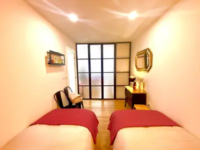 two beds in a room with a window at Cristelo 0 - near the river Porto in Porto