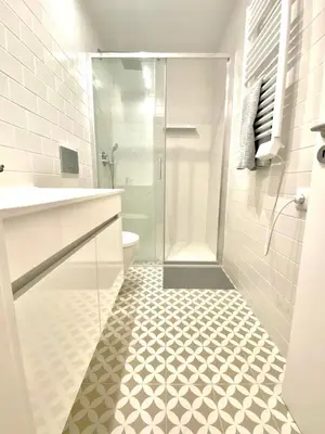 a white bathroom with a shower and a toilet at Cristelo 0 - near the river Porto in Porto