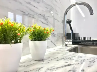 two white vases with flowers on a kitchen counter at Cristelo 2 - near the river Porto in Porto