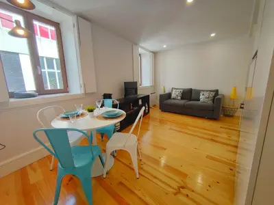a living room with a table and chairs and a couch at Cristelo 2 - near the river Porto in Porto
