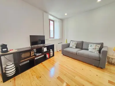 a living room with a couch and a tv at Cristelo 2 - near the river Porto in Porto