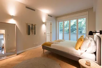 a bedroom with a bed and a large window at Luxury City Center Emporium in Porto
