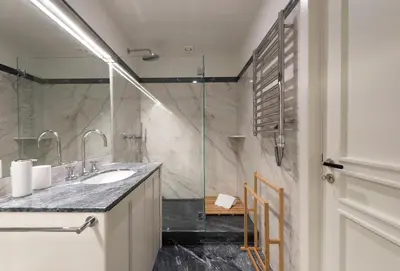 a bathroom with a sink and a glass shower at Luxury City Center Emporium in Porto