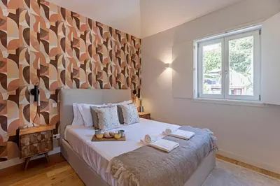 a bedroom with a bed and a large window at Wonderful Flat Near River w/ AC by LovelyStay in Porto