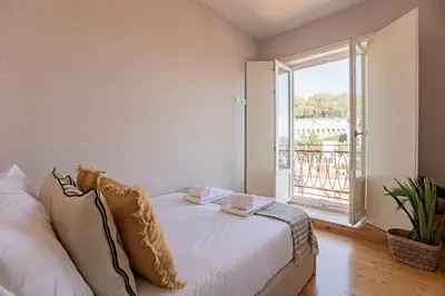a bedroom with a bed and a large window at Wonderful Flat Near River w/ AC by LovelyStay in Porto